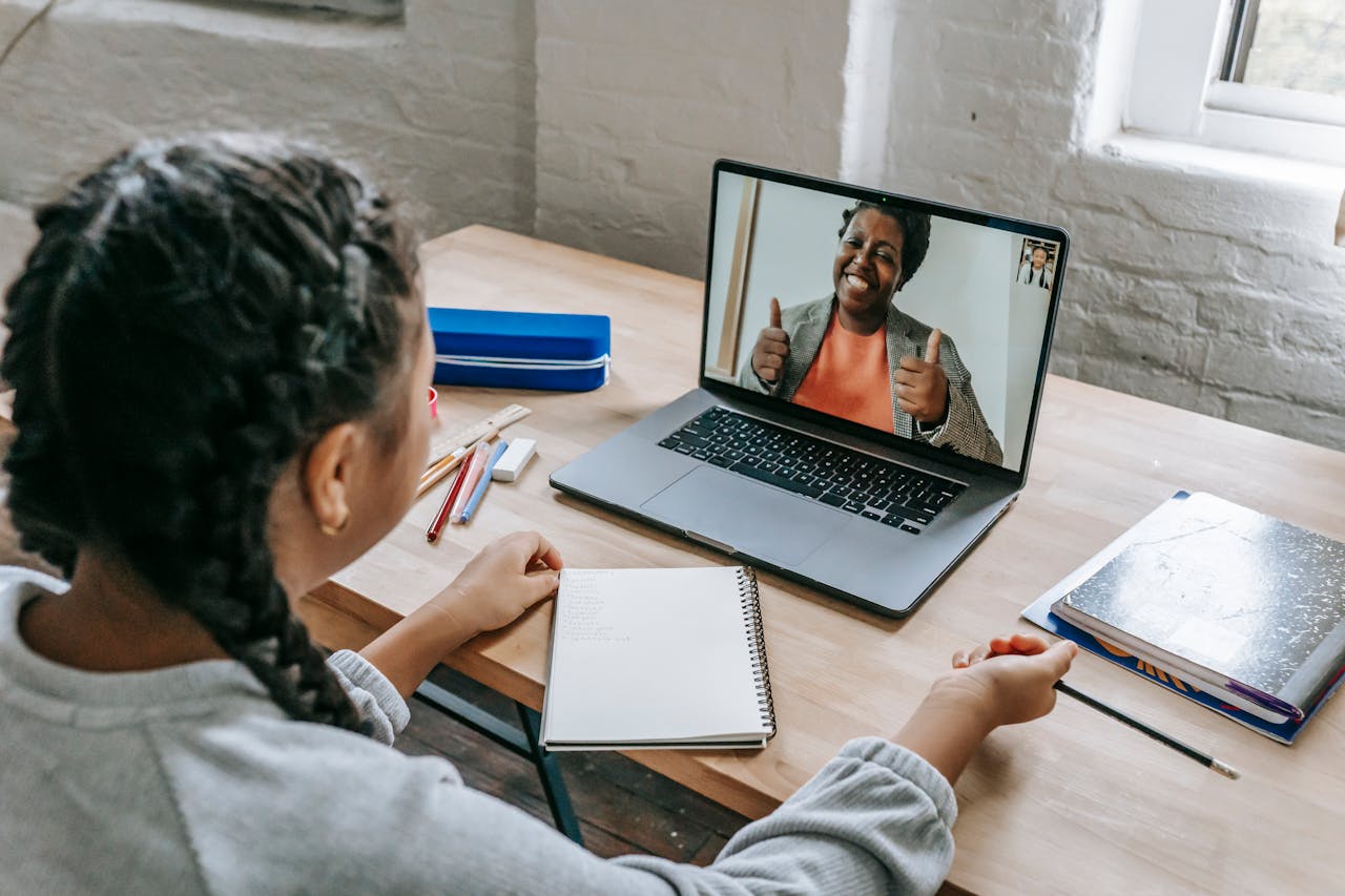 A young student connecting with a teacher via video call for an online lesson.